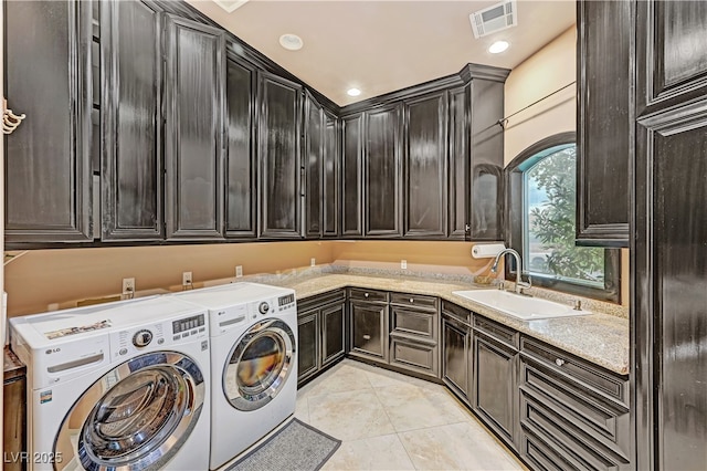 7751 Radcliff St, Las Vegas, NV 89123 - laundry area with independent washer and dryer, cabinet space, light tile patterned flooring, and recessed lighting