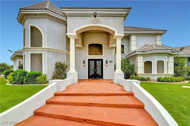 7751 Radcliff St, Las Vegas, NV 89123 - entrance to property featuring french doors, stucco siding, and a lawn