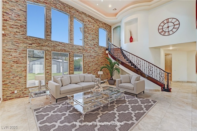 7751 Radcliff St, Las Vegas, NV 89123 - tiled living area featuring a towering ceiling and stairs