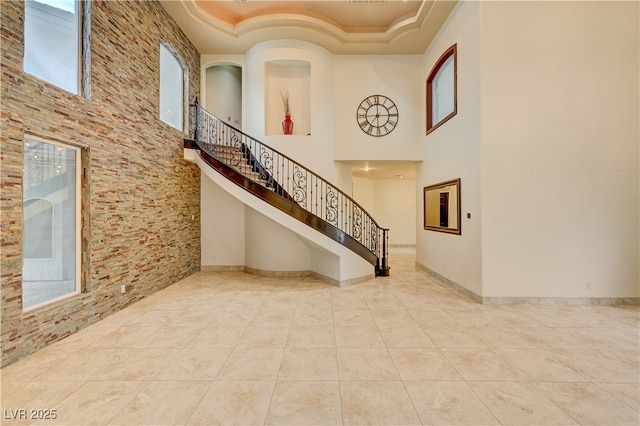 7751 Radcliff St, Las Vegas, NV 89123 - foyer with a high ceiling, plenty of natural light, stairs, tile patterned floors, and crown molding