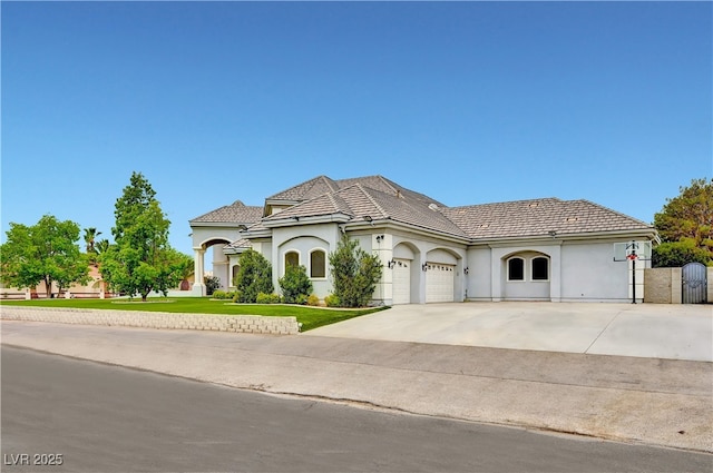 7751 Radcliff St, Las Vegas, NV 89123 - mediterranean / spanish-style home featuring driveway, an attached garage, stucco siding, and a front yard