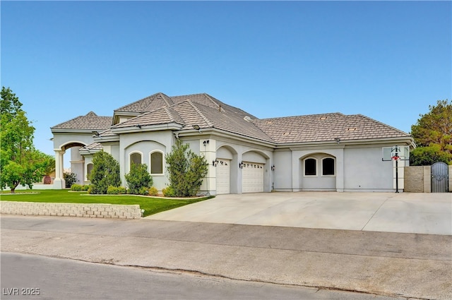 7751 Radcliff St, Las Vegas, NV 89123 - view of front of house with driveway, a garage, stucco siding, and a front lawn