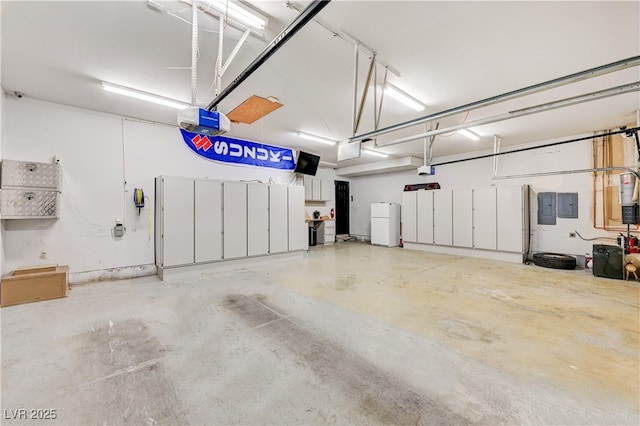7751 Radcliff St, Las Vegas, NV 89123 - garage with electric panel, a garage door opener, and freestanding refrigerator