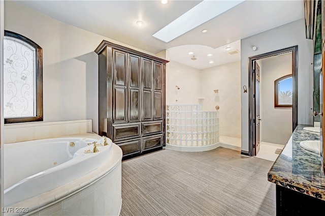 7751 Radcliff St, Las Vegas, NV 89123 - full bathroom featuring double vanity, a tub with jets, and recessed lighting