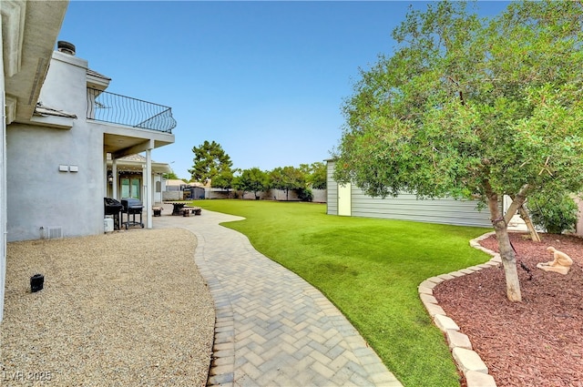 7751 Radcliff St, Las Vegas, NV 89123 - fenced backyard featuring a balcony, a patio area, and an outdoor structure