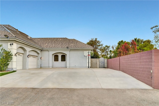 7751 Radcliff St, Las Vegas, NV 89123 - view of property exterior featuring driveway, stucco siding, an attached garage, and a tiled roof