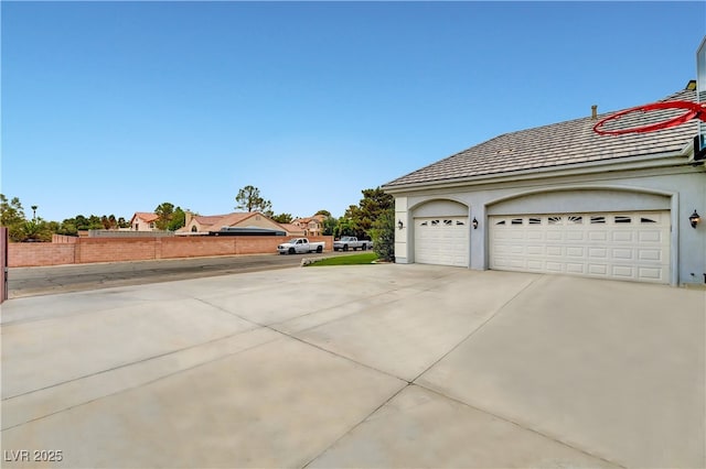 7751 Radcliff St, Las Vegas, NV 89123 - view of side of home with stucco siding and a garage