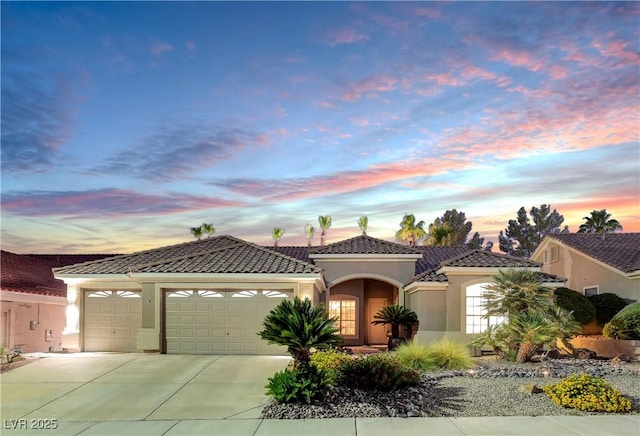 216 Chestnut Ridge Cir, Henderson, NV 89012 - mediterranean / spanish home with stucco siding, a garage, a tiled roof, and concrete driveway