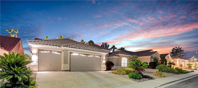 216 Chestnut Ridge Cir, Henderson, NV 89012 - mediterranean / spanish home with a tiled roof, a garage, concrete driveway, and stucco siding