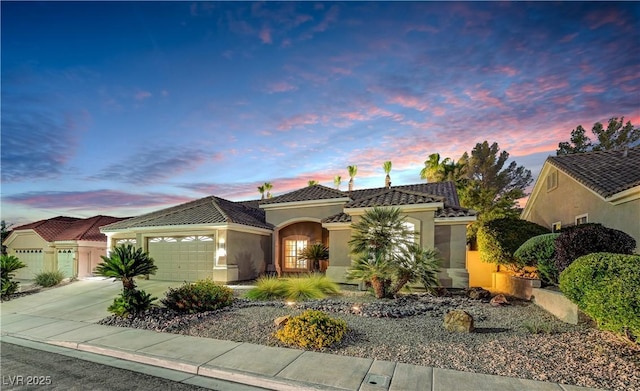 216 Chestnut Ridge Cir, Henderson, NV 89012 - mediterranean / spanish house with a tiled roof, an attached garage, stucco siding, and driveway
