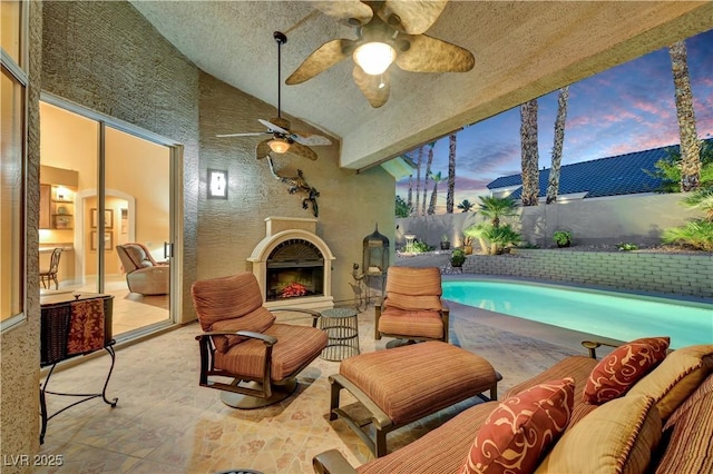 216 Chestnut Ridge Cir, Henderson, NV 89012 - fenced backyard featuring an outdoor living space with a fireplace, a patio, and a ceiling fan