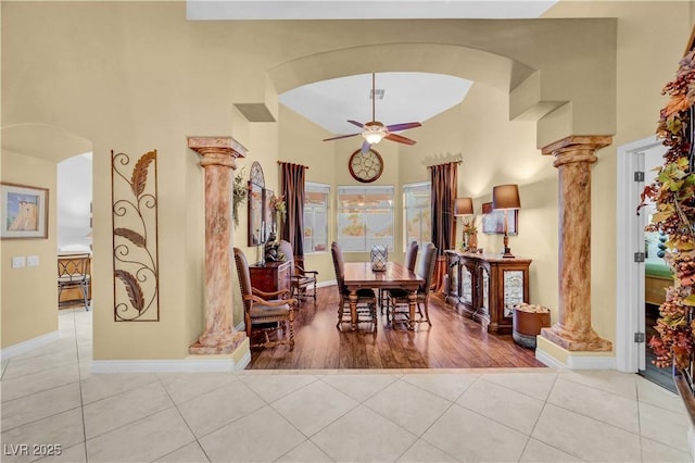 216 Chestnut Ridge Cir, Henderson, NV 89012 - tiled dining room with decorative columns, arched walkways, a towering ceiling, and ceiling fan