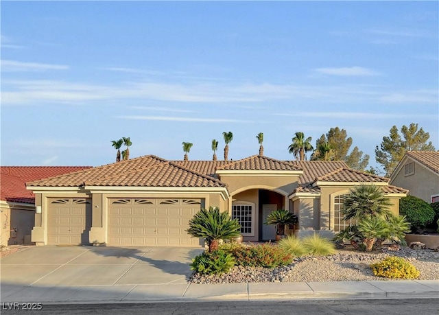 216 Chestnut Ridge Cir, Henderson, NV 89012 - mediterranean / spanish-style house with a garage, stucco siding, concrete driveway, and a tiled roof