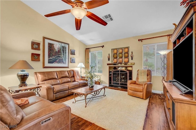 216 Chestnut Ridge Cir, Henderson, NV 89012 - living room with vaulted ceiling, ceiling fan, hardwood / wood-style flooring, healthy amount of natural light, and a tile fireplace
