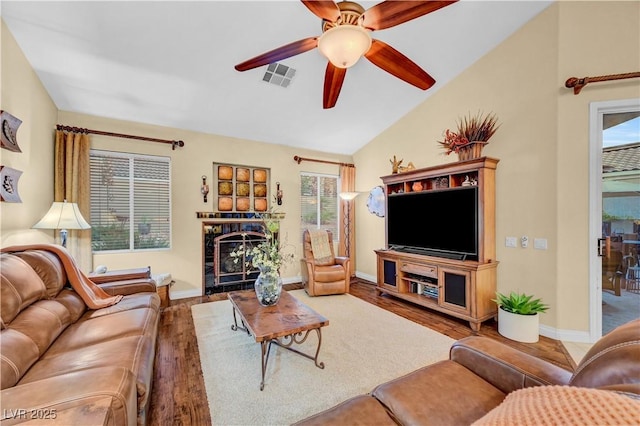 216 Chestnut Ridge Cir, Henderson, NV 89012 - living area featuring a fireplace, a ceiling fan, wood finished floors, and vaulted ceiling