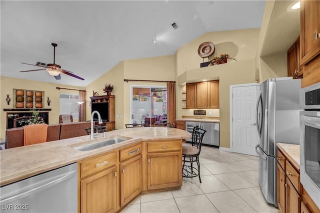 216 Chestnut Ridge Cir, Henderson, NV 89012 - kitchen with stainless steel appliances, light countertops, healthy amount of natural light, ceiling fan, and high vaulted ceiling