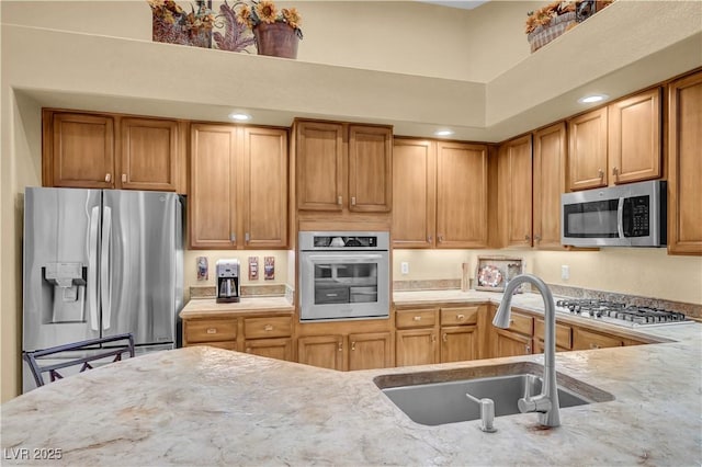 216 Chestnut Ridge Cir, Henderson, NV 89012 - kitchen with stainless steel appliances, light stone counters, and brown cabinets