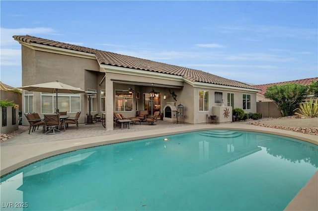 216 Chestnut Ridge Cir, Henderson, NV 89012 - rear view of property featuring stucco siding, a tiled roof, and a patio
