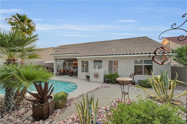 216 Chestnut Ridge Cir, Henderson, NV 89012 - back of house featuring a tiled roof, stucco siding, and an outdoor pool