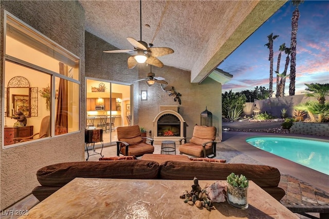 216 Chestnut Ridge Cir, Henderson, NV 89012 - patio terrace at dusk featuring outdoor lounge area, a ceiling fan, and a patio area