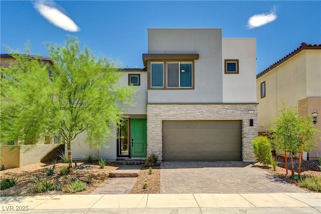 1305 Azure Jay Ave, North Las Vegas, NV 89084 - contemporary home featuring decorative driveway, a garage, stone siding, and stucco siding