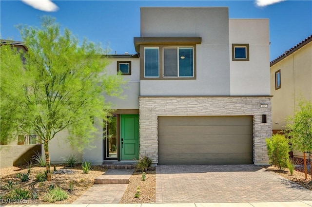 1305 Azure Jay Ave, North Las Vegas, NV 89084 - contemporary house with decorative driveway, stone siding, an attached garage, and stucco siding
