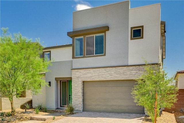 1305 Azure Jay Ave, North Las Vegas, NV 89084 - contemporary home with an attached garage, stucco siding, stone siding, and driveway