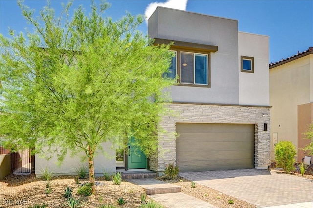 1305 Azure Jay Ave, North Las Vegas, NV 89084 - contemporary home with stone siding, decorative driveway, a garage, and stucco siding