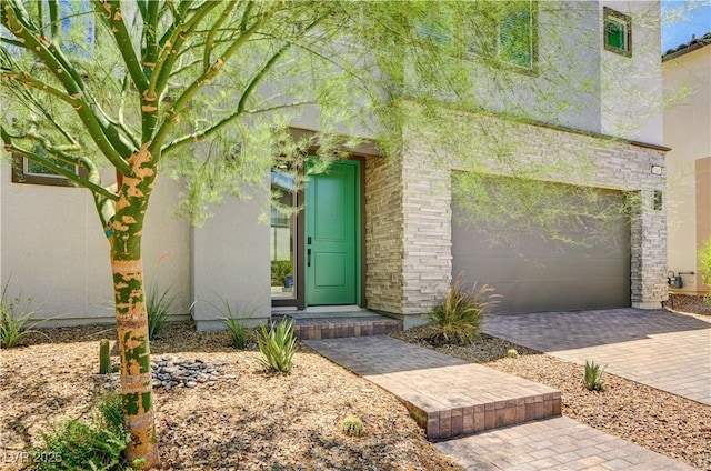 1305 Azure Jay Ave, North Las Vegas, NV 89084 - doorway to property with a garage, stucco siding, and decorative driveway