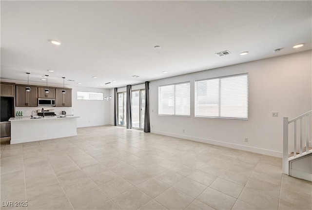 1305 Azure Jay Ave, North Las Vegas, NV 89084 - unfurnished living room with plenty of natural light, recessed lighting, and stairs