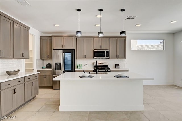 1305 Azure Jay Ave, North Las Vegas, NV 89084 - kitchen featuring stainless steel appliances, light countertops, tasteful backsplash, light tile patterned floors, and recessed lighting