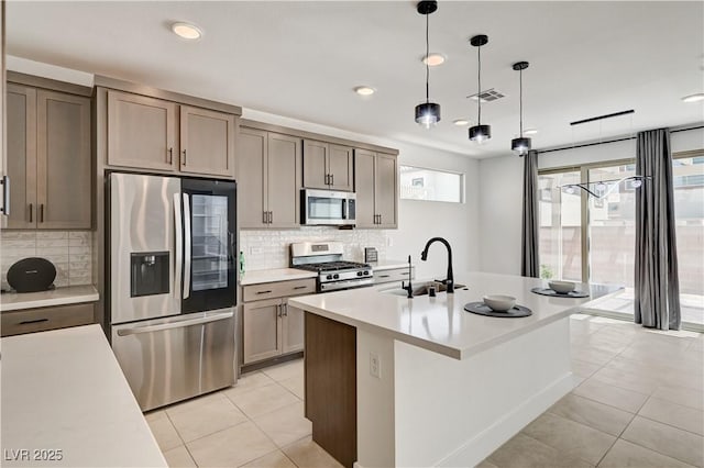1305 Azure Jay Ave, North Las Vegas, NV 89084 - kitchen featuring stainless steel appliances, light tile patterned floors, backsplash, light countertops, and recessed lighting