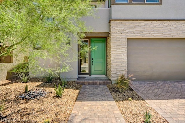 1305 Azure Jay Ave, North Las Vegas, NV 89084 - property entrance featuring stucco siding, decorative driveway, and a garage