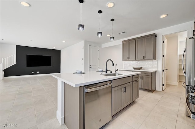 1305 Azure Jay Ave, North Las Vegas, NV 89084 - kitchen featuring stainless steel appliances, recessed lighting, light countertops, backsplash, and a center island with sink