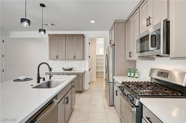 1305 Azure Jay Ave, North Las Vegas, NV 89084 - kitchen with stainless steel appliances, light countertops, backsplash, and recessed lighting