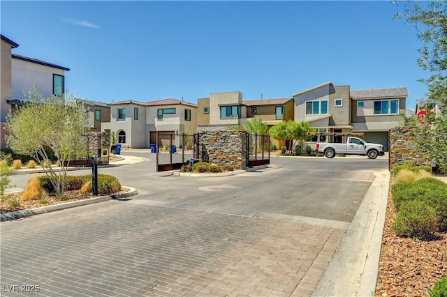 1305 Azure Jay Ave, North Las Vegas, NV 89084 - view of decorative road with a residential view, curbs, a gate, and a gated entry