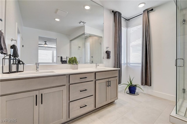 1305 Azure Jay Ave, North Las Vegas, NV 89084 - bathroom featuring ceiling fan, a shower stall, double vanity, tile patterned flooring, and recessed lighting