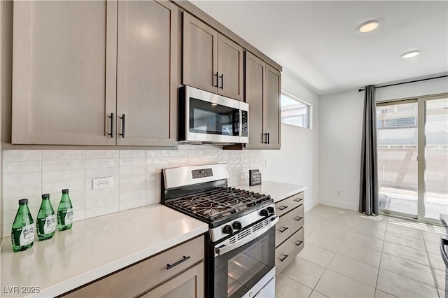 1305 Azure Jay Ave, North Las Vegas, NV 89084 - kitchen featuring stainless steel appliances, tasteful backsplash, light countertops, light tile patterned floors, and recessed lighting
