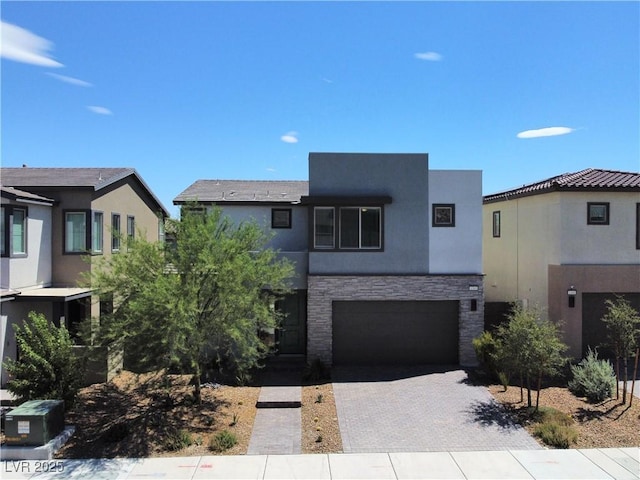1305 Azure Jay Ave, North Las Vegas, NV 89084 - modern home with stone siding, a garage, stucco siding, and decorative driveway