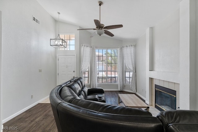 5621 Desert Creek Way, Las Vegas, NV 89149 - living area with lofted ceiling, a chandelier, wood finished floors, a tile fireplace, and a ceiling fan
