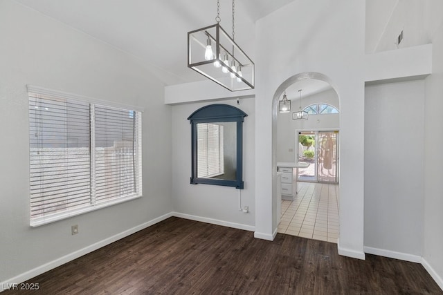 5621 Desert Creek Way, Las Vegas, NV 89149 - entrance foyer with wood finished floors, high vaulted ceiling, a chandelier, and arched walkways
