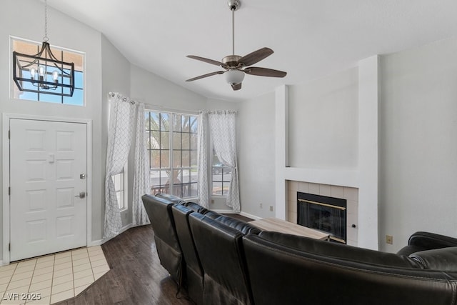 5621 Desert Creek Way, Las Vegas, NV 89149 - living room featuring lofted ceiling, healthy amount of natural light, a tile fireplace, wood finished floors, and ceiling fan