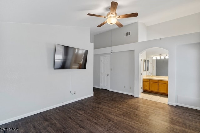 5621 Desert Creek Way, Las Vegas, NV 89149 - unfurnished bedroom featuring arched walkways, wood finished floors, high vaulted ceiling, ensuite bath, and ceiling fan