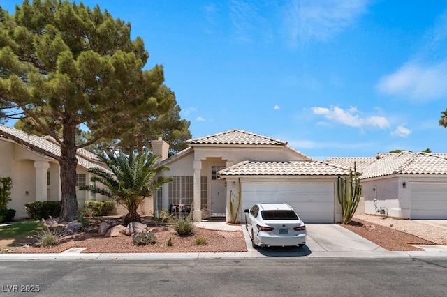 5621 Desert Creek Way, Las Vegas, NV 89149 - mediterranean / spanish home featuring stucco siding, a garage, driveway, a tile roof, and a chimney