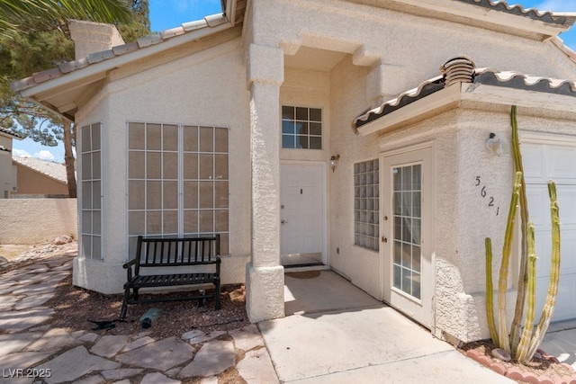 5621 Desert Creek Way, Las Vegas, NV 89149 - property entrance with a tiled roof and stucco siding