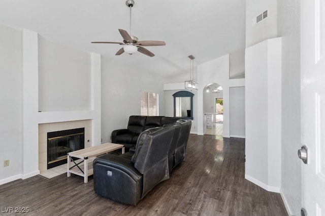 5621 Desert Creek Way, Las Vegas, NV 89149 - living room featuring a tile fireplace, a ceiling fan, wood finished floors, arched walkways, and high vaulted ceiling