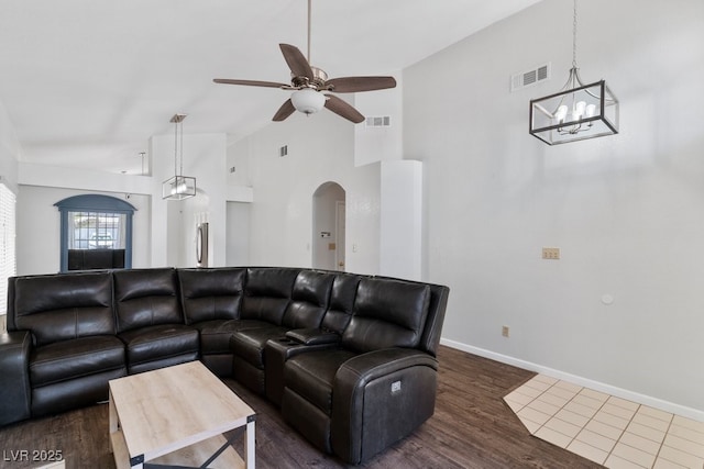 5621 Desert Creek Way, Las Vegas, NV 89149 - living area featuring a chandelier, high vaulted ceiling, arched walkways, a ceiling fan, and dark wood-style floors