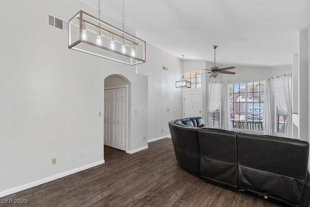 5621 Desert Creek Way, Las Vegas, NV 89149 - living room with vaulted ceiling, arched walkways, ceiling fan, and dark wood-style flooring