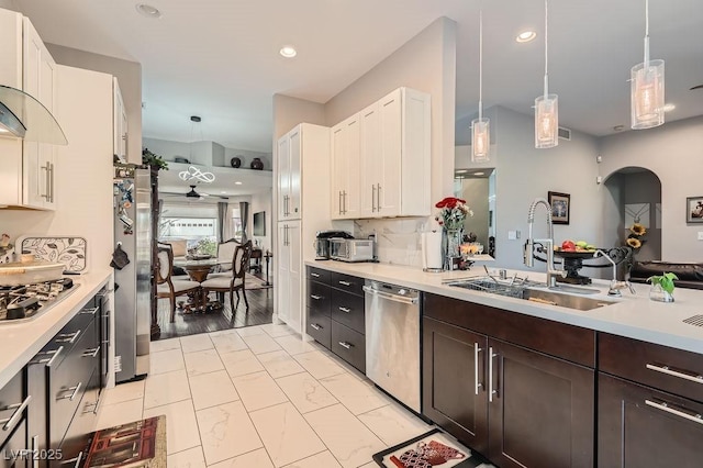 5021 Cliffrose Dr, Las Vegas, NV 89130 - kitchen with appliances with stainless steel finishes, light countertops, white cabinets, dark brown cabinets, and recessed lighting