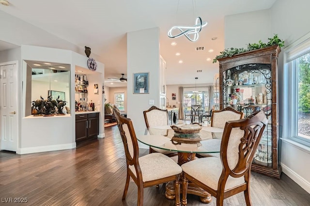 5021 Cliffrose Dr, Las Vegas, NV 89130 - dining area featuring wood finished floors, a chandelier, ceiling fan, and a dry bar